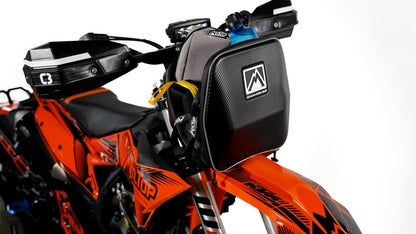 MTN.TOP Number Plate Bag mounted on the front of an orange MTN.TOP snowbike, side view