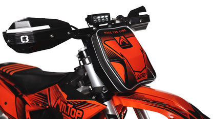MTN.TOP Number Plate Bag with orange graphic kit mounted on the front of a snowbike